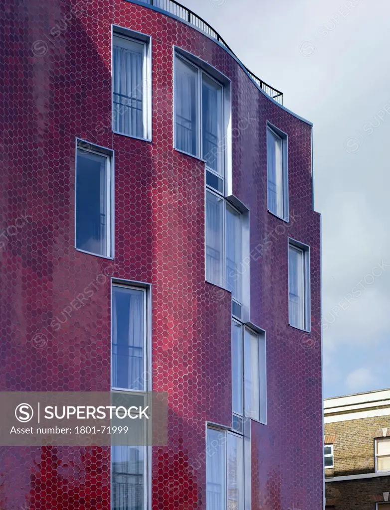 Brandon Street Housing, London, United Kingdom. Architect Metaphorm, 2012. Upward looking view of curved ceramic facade.