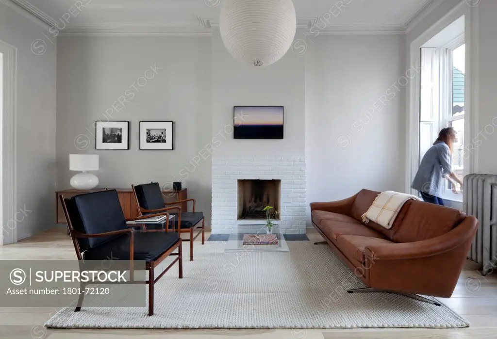 Park Slope, Brooklyn Residence, Brooklyn, United States. Architect Davies Tang & Toews , 2012. Vintage modern furniture, fireplace, Isamu Noguchi Akari fixture ceiling light.