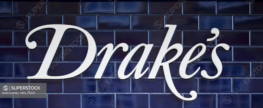Drake's, London, United Kingdom. Architect William Russell, 2011. Drake's branding on the blue tiles that clad the exterior of the store.