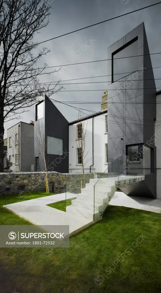 Private Residence Castlewood, Rathmines, Ireland. Architect ODOS, 2008. View of two extensions from garden showing stairs.