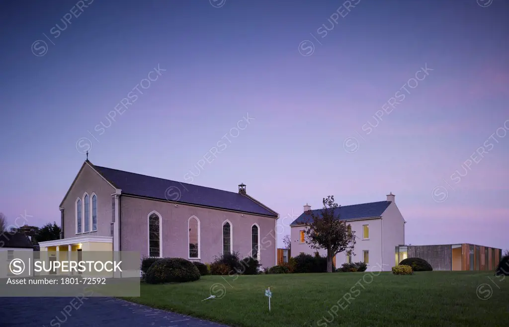 Knocktopher Friary, Knocktopher, Ireland. Architect ODOS, 2006. View of church showing original friary and cloister at dusk.