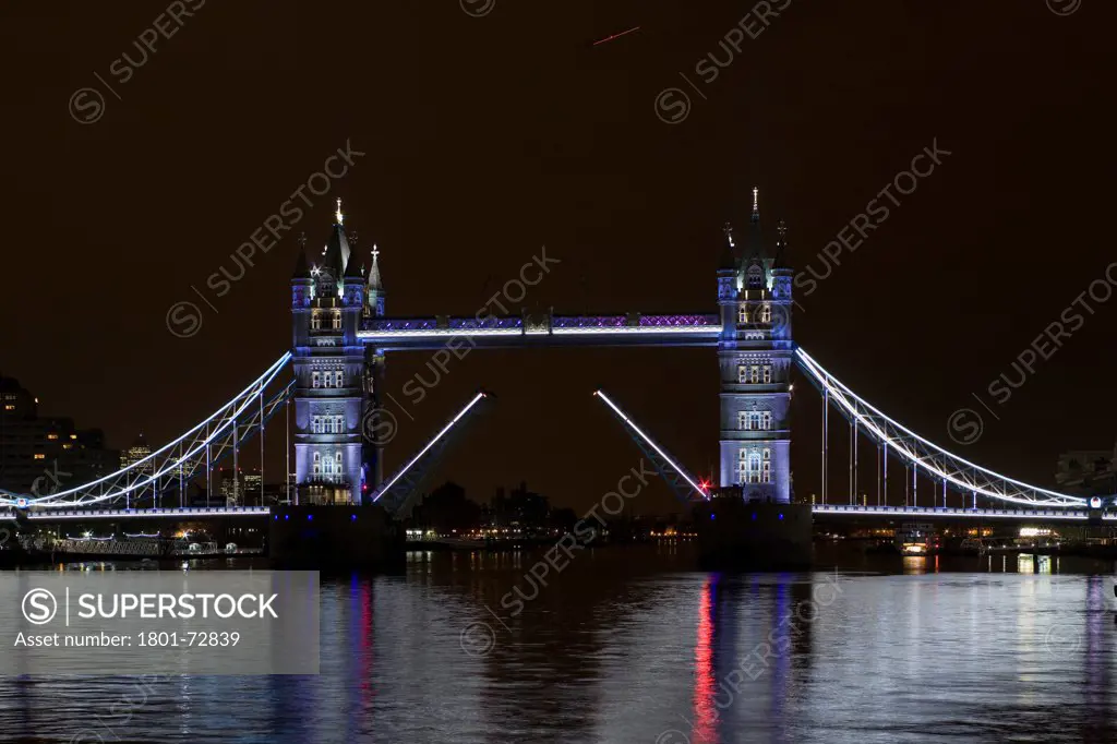 Tower Bridge Re-lighting, London, United Kingdom. Architect Horace Jones, 2012. View of Tower Bridge capturing new lighting system from HMS Belfast.
