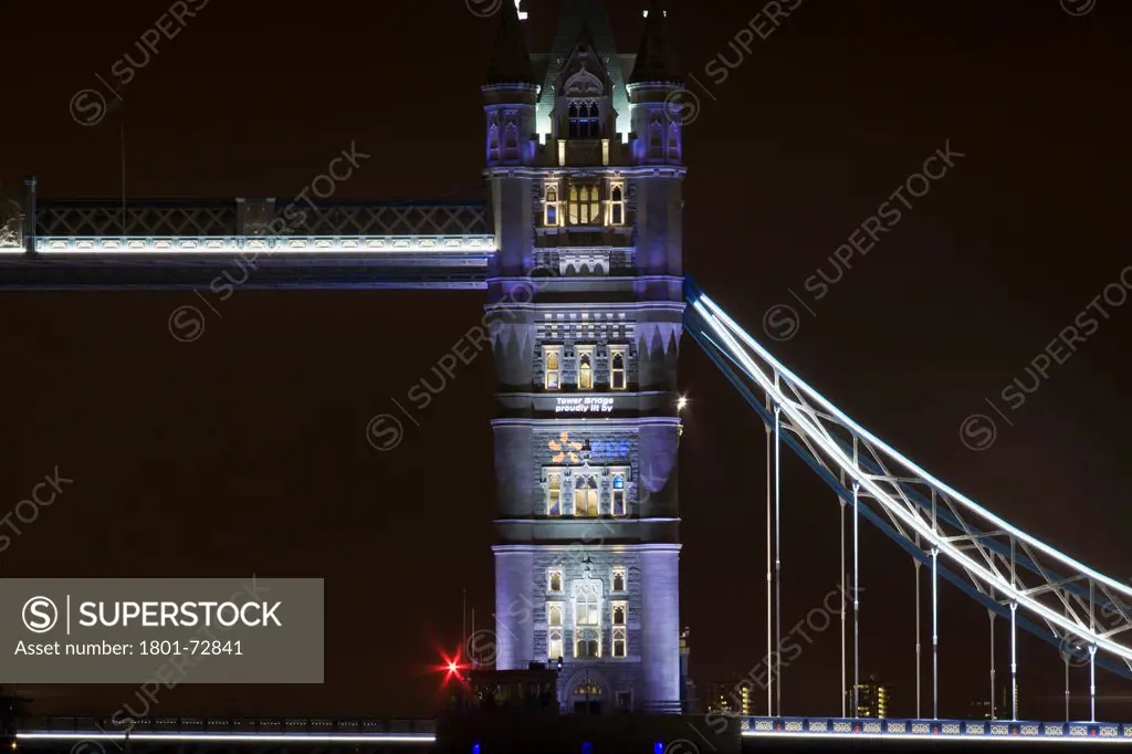 Tower Bridge Re-lighting, London, United Kingdom. Architect Horace Jones, 2012. Detail View of Tower Bridge capturing new lighting system from HMS Belfast.