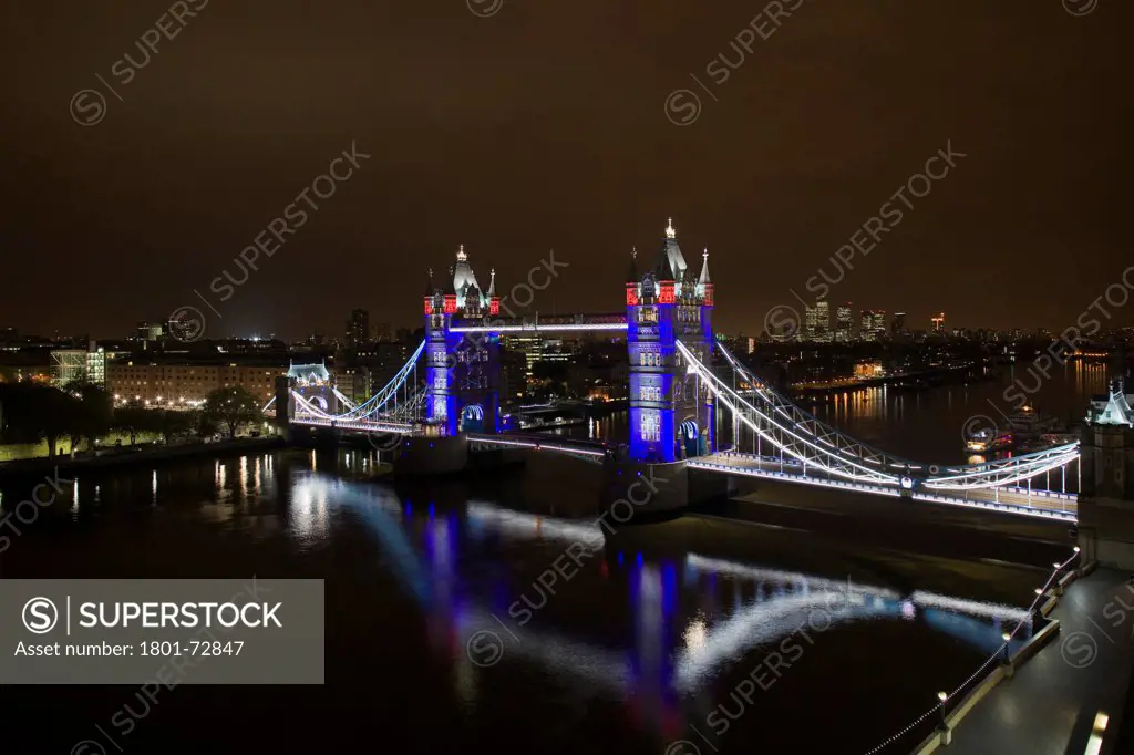 Tower Bridge Re-lighting, London, United Kingdom. Architect Horace Jones, 2012. View of Tower Bridge capturing new lighting system from GLA Building. Red, White & Blue lighting.