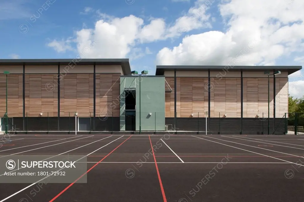 Trinity School Sports Hall, Newbury, United Kingdom. Architect ADP Architects Ltd, 2012. Exterior view across all weather sports pitch to south facade of sports hall.