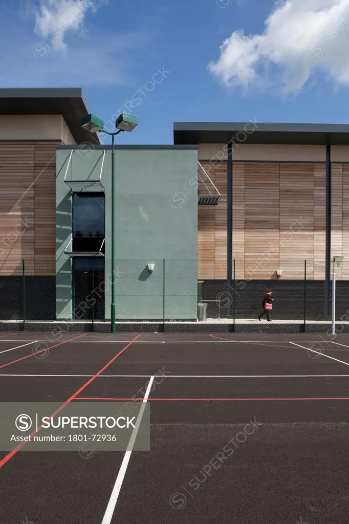 Trinity School Sports Hall, Newbury, United Kingdom. Architect ADP Architects Ltd, 2012. View across all weather sports pitch of sports hall south elevation.