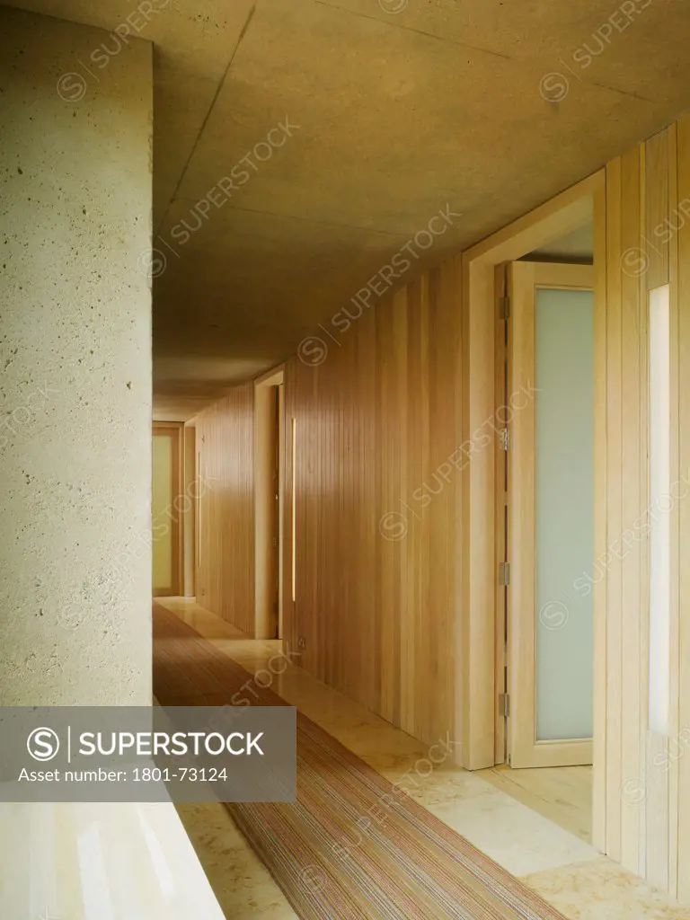 Strand House, Rosslare, Ireland. Architect O'Donnell & Tuomey, 2008. View of corridor showing exposed concrete and timber finishings.