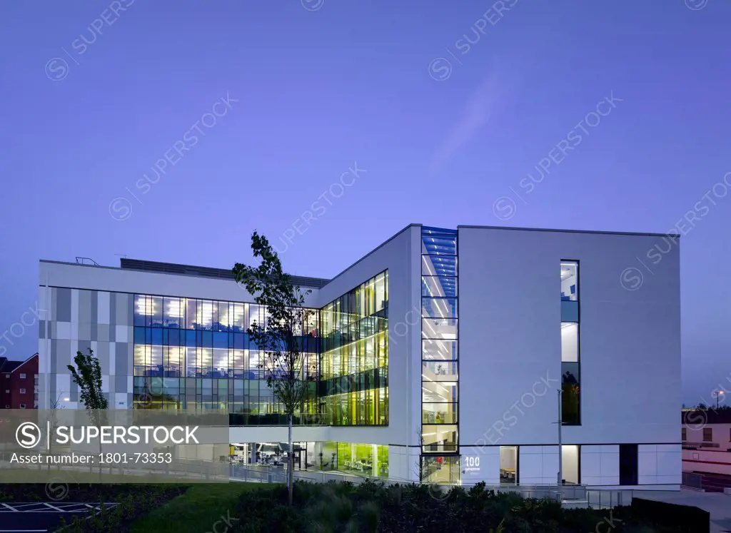 Office Building for Walsall Housing Group, Office, Europe, United Kingdom, West Midlands, 2012, Bisset Adams. Back side view of l-shaped office block with landscaped green at dusk.