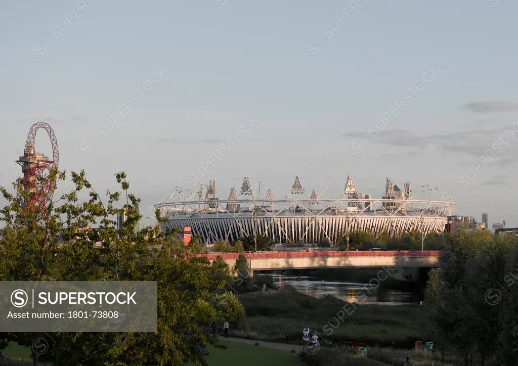 Olympic Stadium London 2012, Stadium, Europe, United Kingdom,2012, Populous. General view of Stadium with Arcelormittal Orbit by Anish Kapoor on left and park in foreground.