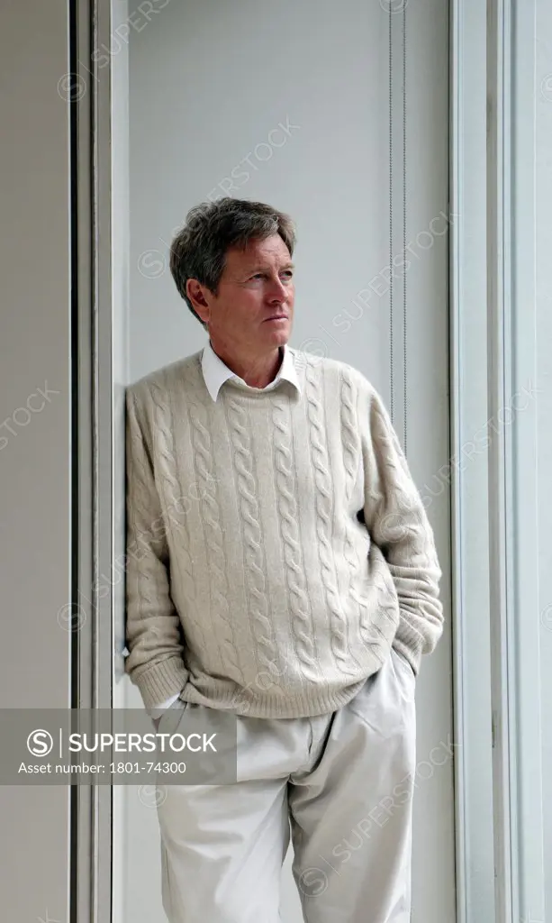 John Pawson at home, London, United Kingdom. Architect: John Pawson, 2010. Portrait of John Pawson, Architect leaning against a corner of a wall in his home in St John's Wood, North West London. Looking out to right-hand side of the frame.