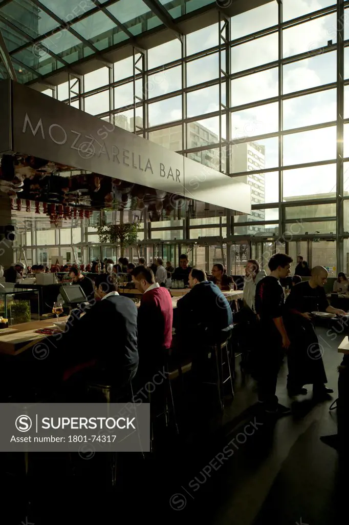 Obika Canary Wharf, London, United Kingdom. Architect: Labics, 2012. Customers seated at mozzarella bar.