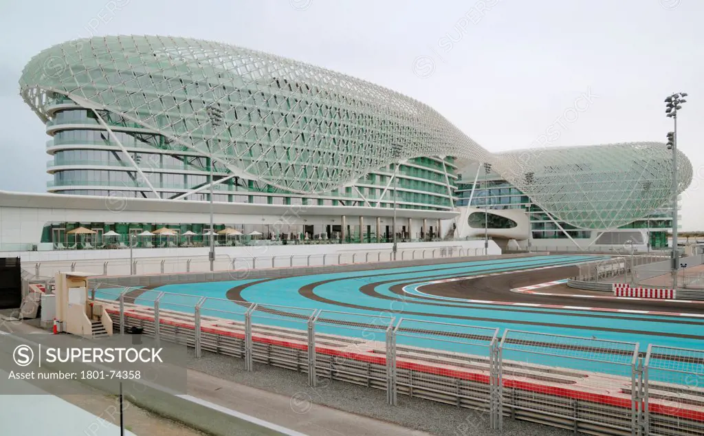 Yas Hotel, Abu Dhabi, United Arab Emirates. Architect: Asymptote, Hani Rashid, Lise Anne Couture, 2010. General view with race track.