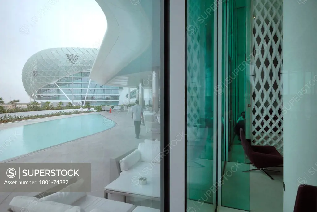 Yas Hotel, Abu Dhabi, United Arab Emirates. Architect: Asymptote, Hani Rashid, Lise Anne Couture, 2010. View of the pool through curtain wall.