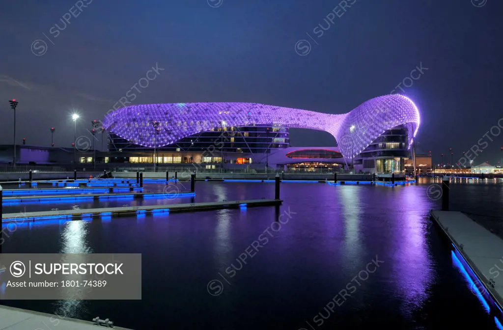 Yas Hotel, Abu Dhabi, United Arab Emirates. Architect: Asymptote, Hani Rashid, Lise Anne Couture, 2010. General view from Marina with changing color LED skin.