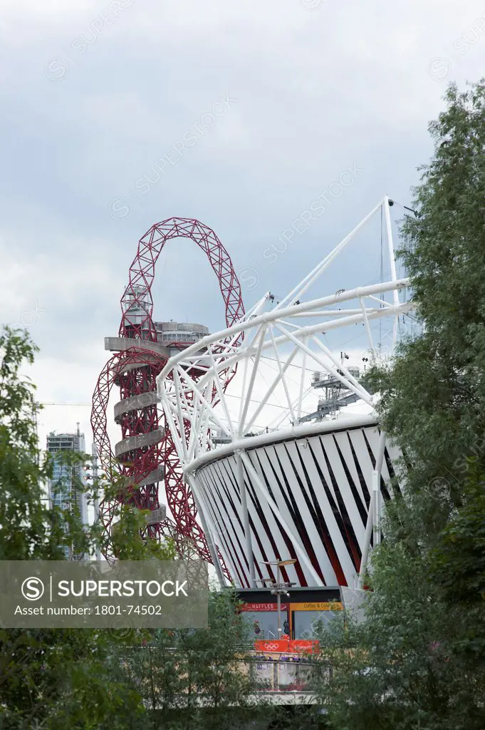 Olympic Stadium, London Olympics 2012, London, United Kingdom. Architect: Populous , 2012. Exterior with ArcelorMittal Orbit behind.