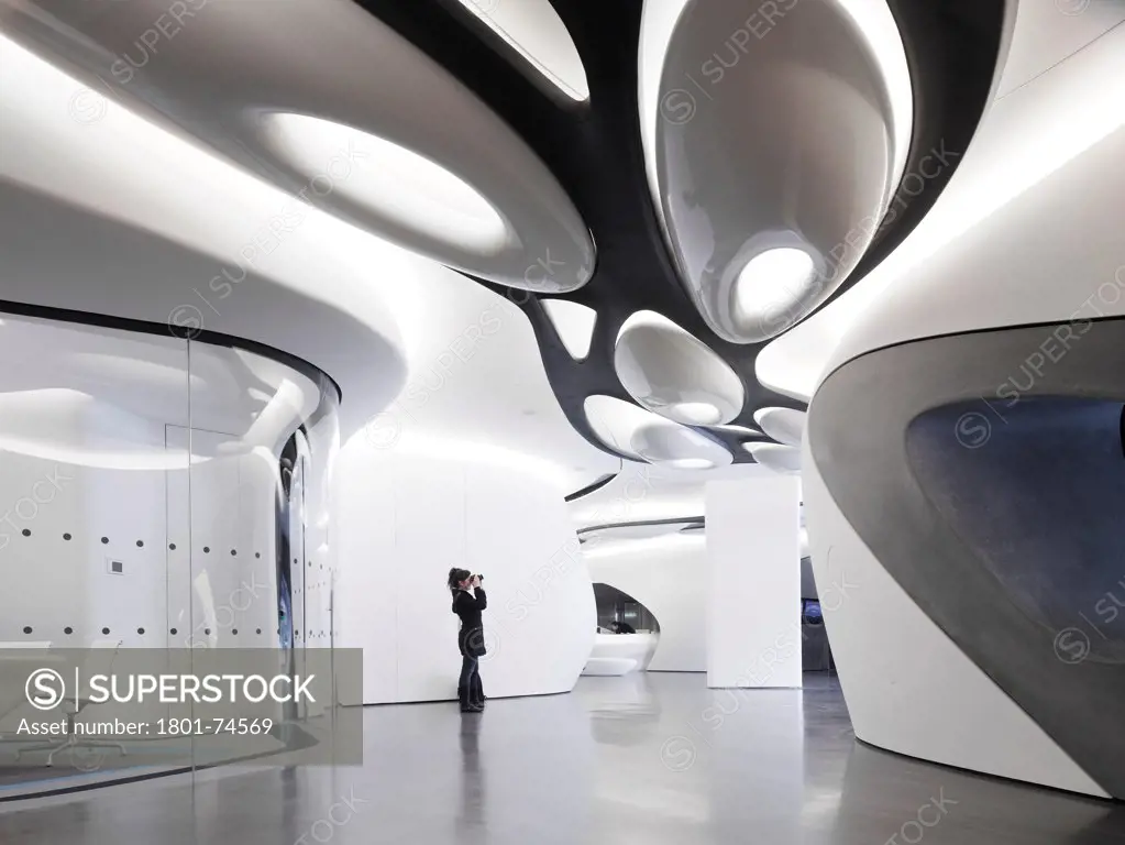 Roca London Gallery, London, United Kingdom. Architect: Zaha Hadid, 2011. Passageway with person taking picture.