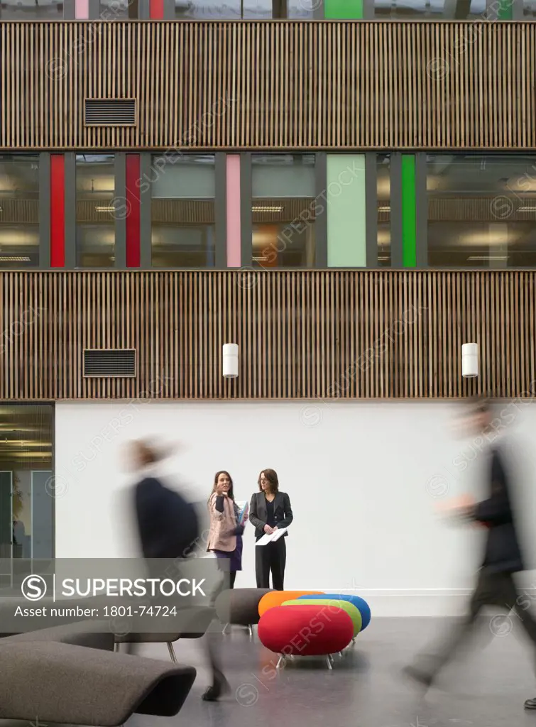 Stanley Park High School, Sutton, United Kingdom. Architect: Haverstock Associates LLP, 2011. Frontal view of interior timber facade with atrium seating arrangements.