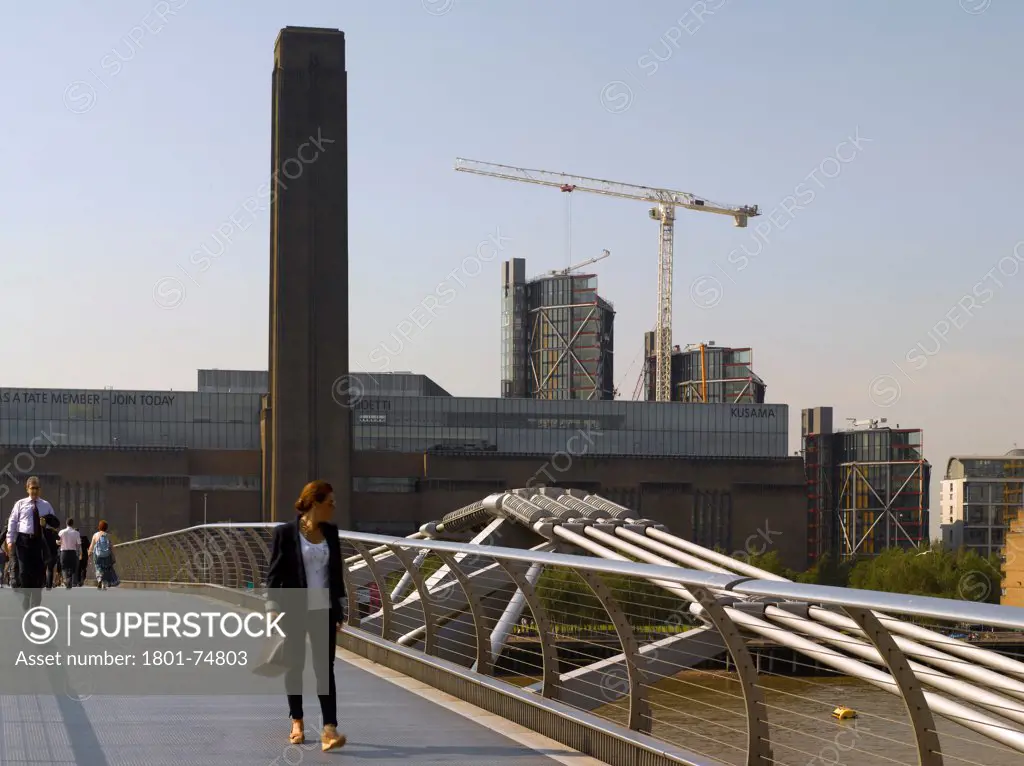 Neo Bankside, London, United Kingdom. Architect: Rogers Stirk Harbour + Partners, 2011. View from Millennium Pedestrian Bridge with passing figure.