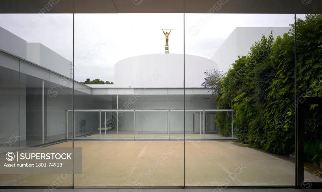 21st Century Museum, Kanazawa, Japan. Architect: SANAA, 2012. Overall interior view showing courtyard with living wall.