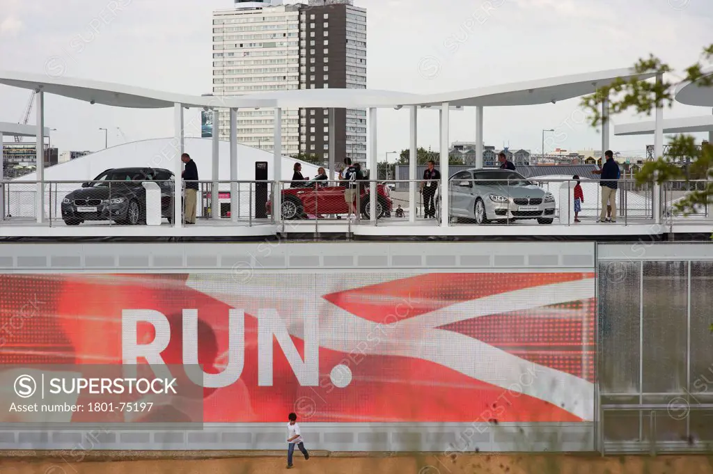 BMW Group Pavilion London 2012, London, United Kingdom. Architect: Serie Architects, 2012. View from the west with run logo and boy running.
