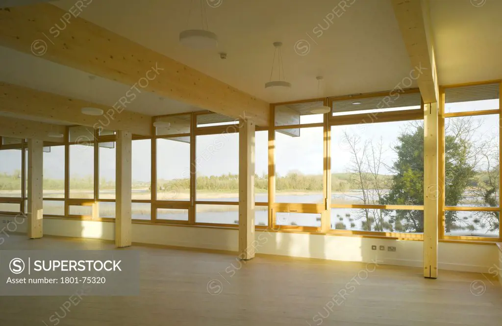 Ballybay Wetland Centre, Ballybay, Ireland. Architect: Solearth Ecological Architecture, 2008. View of main space showing timber supports and view to surrounding landscape.