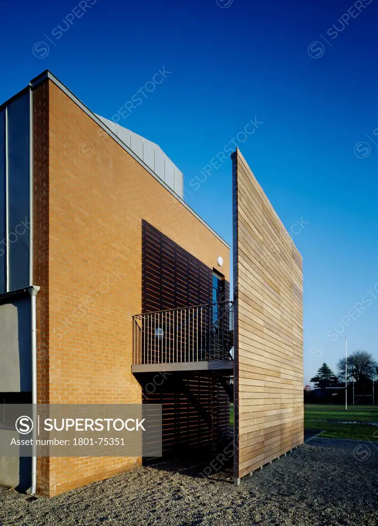 Sandford Park School, Ranelagh, Ireland. Architect: DTA Architects, 2007. View of stairs showing timber and brick cladding.
