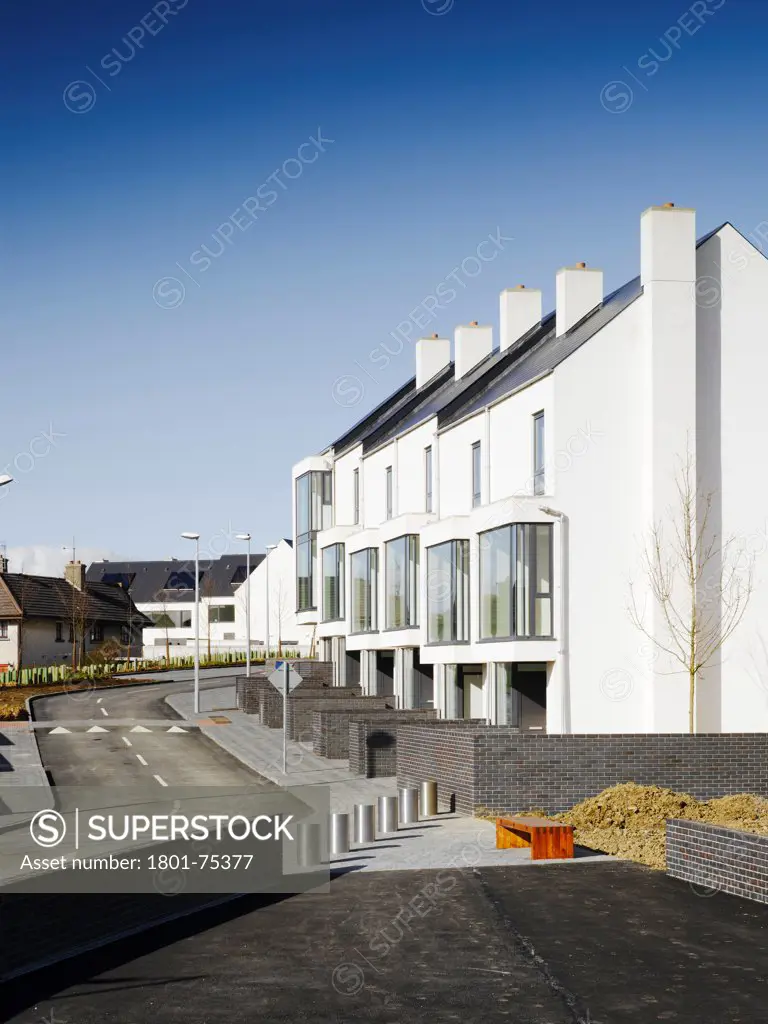 Gleann Bhan, Galway, Ireland. Architect: DTA Architects, 2008. View of terraces showing road and existing buildings.