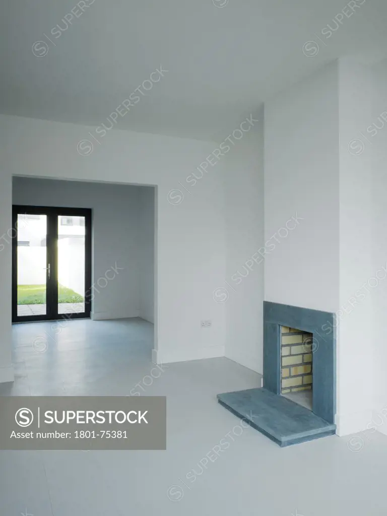 Gleann Bhan, Galway, Ireland. Architect: DTA Architects, 2008. View of living space showing fireplace and view to exterior.