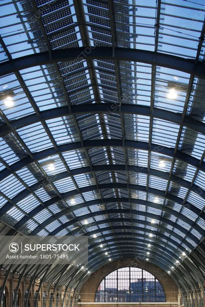 King's Cross Station, Railway Station, Europe, United Kingdom, , 2012, John McAslan & Partners. View of renovated train shed roof at dusk.