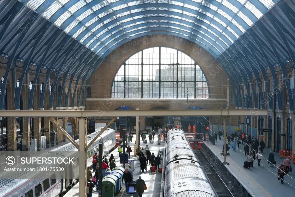 King's Cross Station, Railway Station, Europe, United Kingdom, , 2012, John McAslan & Partners. Elevated view over station platforms with trains and passengers.