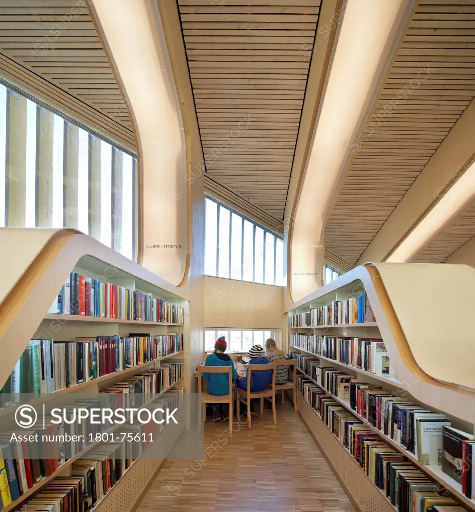Vennesla Library, Library, Europe, Norway, , 2012, Helen & Hard. Interior view in between shelves with people working.