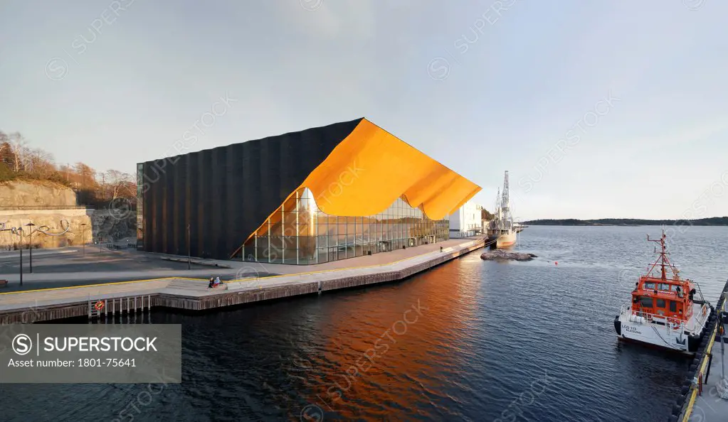 Kilden Performing Arts Centre, Concert Hall, Europe, Norway, , 2011, ALA Architects. Oblique exterior view across water in late afternoon.