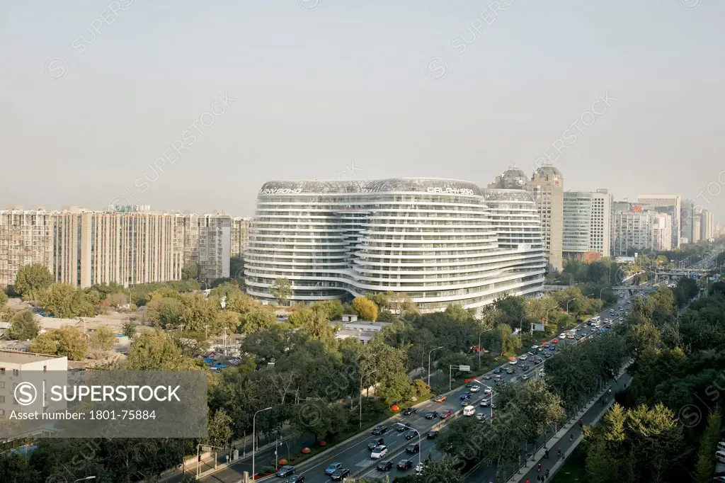 Galaxy Soho, Beijing, China. Architect: Zaha Hadid Architects, 2012. Distant elevated view with cityscape and motorways.