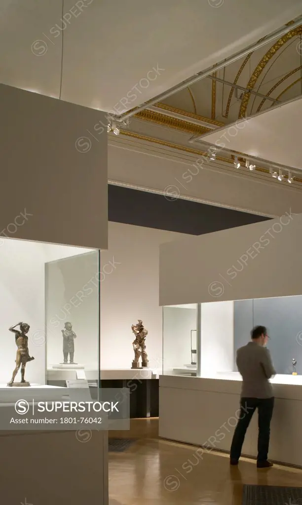 Royal Academy Bronze Exhibition, London, United Kingdom. Architect: Stanton Williams, 2012. Arrangement of lit display cases.