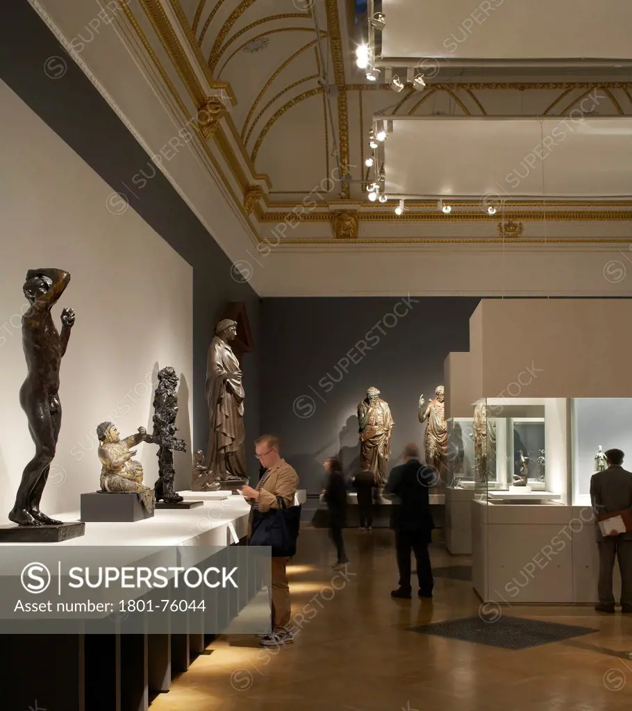 Royal Academy Bronze Exhibition, London, United Kingdom. Architect: Stanton Williams, 2012. Arrangement of lit display cases, sculpture plinths and visitors.