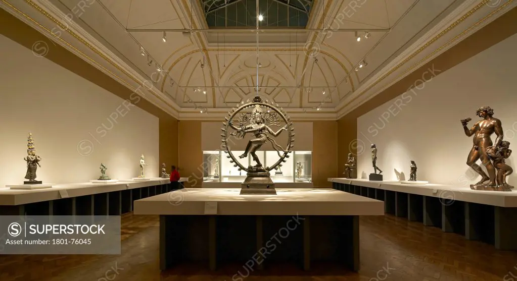 Royal Academy Bronze Exhibition, London, United Kingdom. Architect: Stanton Williams, 2012. Almost symmetrical view of exhibition room with statue of indian hindu god dancing Shiva.