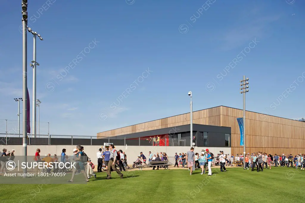 Eton Manor Olympic Park, London, United Kingdom. Architect: Stanton Williams, 2012. Oblique elevation with green and circulating crowd.