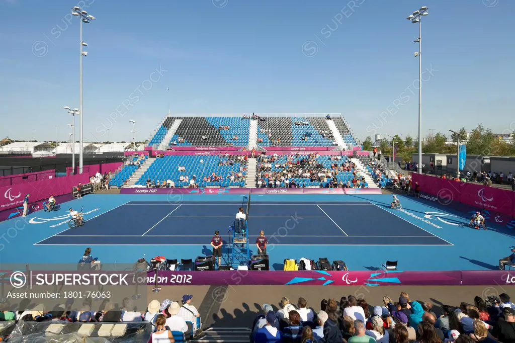 Eton Manor Olympic Park, London, United Kingdom. Architect: Stanton Williams, 2012. Tennis court with tiers during competition.