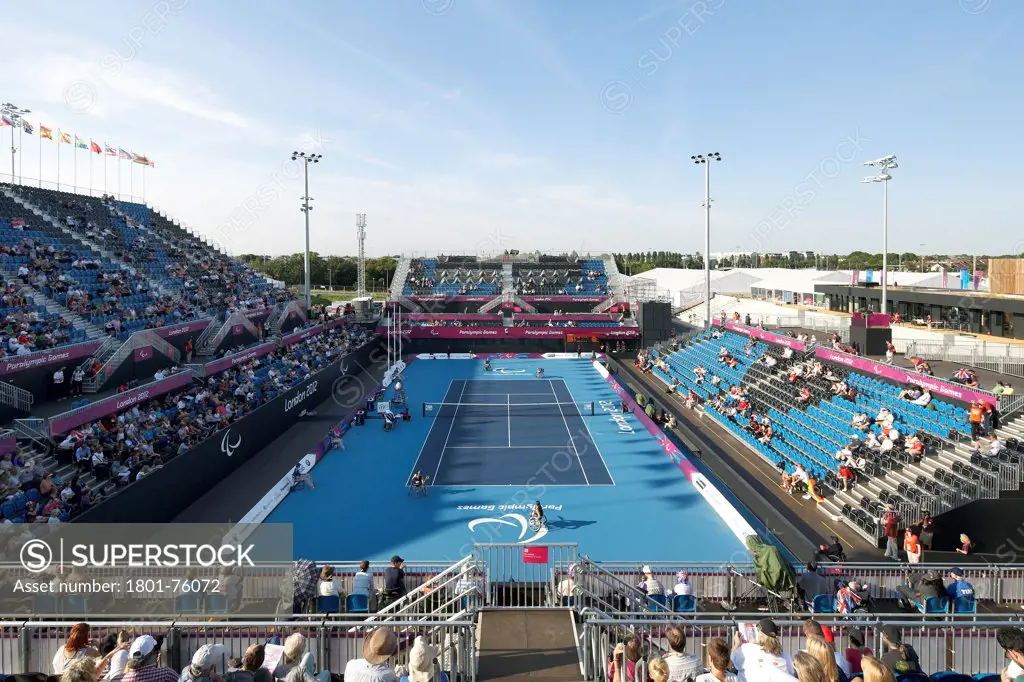 Eton Manor Olympic Park, London, United Kingdom. Architect: Stanton Williams, 2012. Elevated view from stand to tennis court during competition.