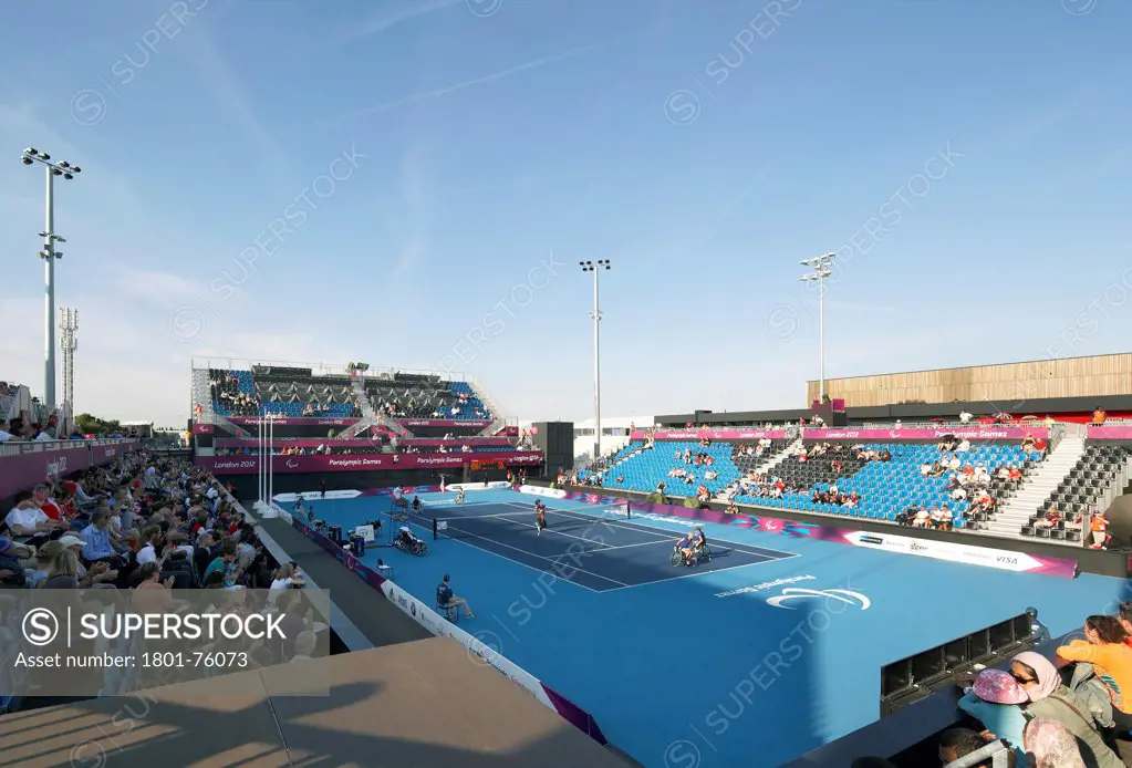 Eton Manor Olympic Park, London, United Kingdom. Architect: Stanton Williams, 2012. Corner view from stand to tennis court during competition.