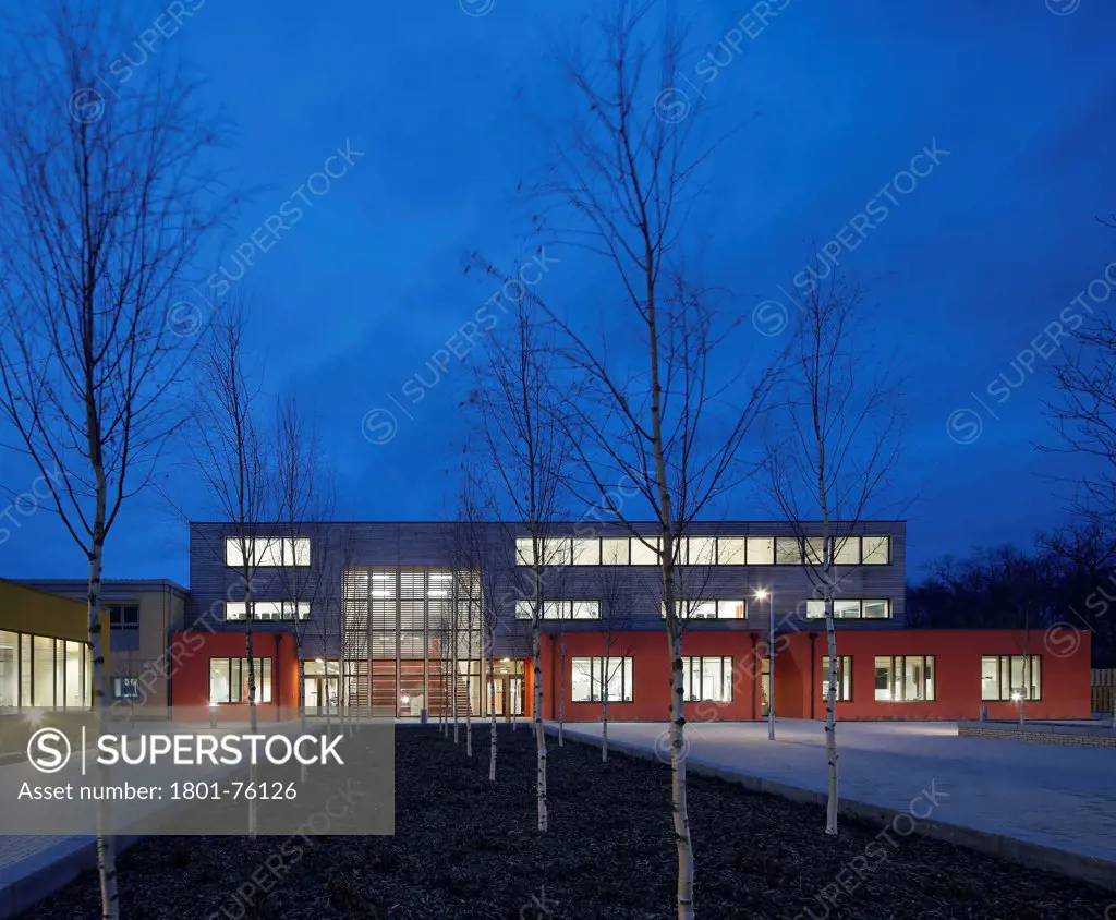 Waingels College, Reading, United Kingdom. Architect: Sheppard Robson, 2011. Front elevation of classroom building at dusk.