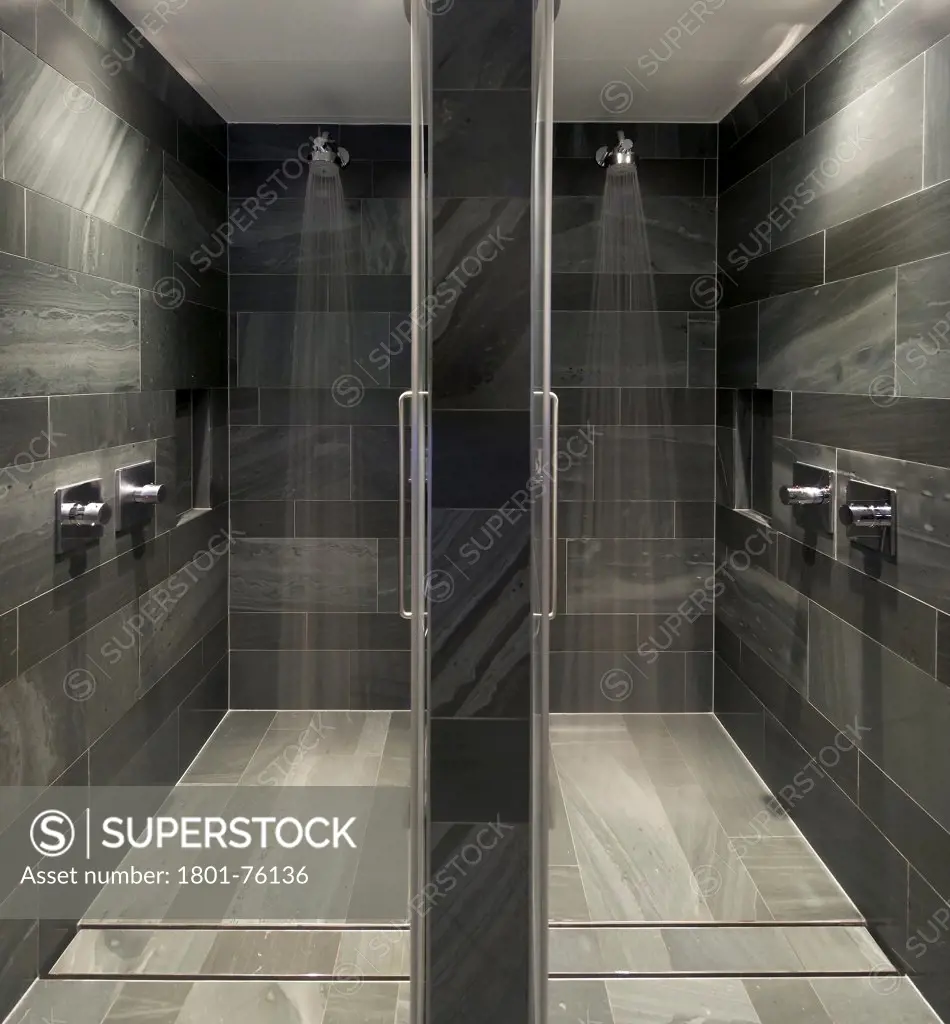 Kinesis Spa, London, United Kingdom. Architect: Squire + Partners , 2012. Symmetrical view into slate-clad shower cubicles.