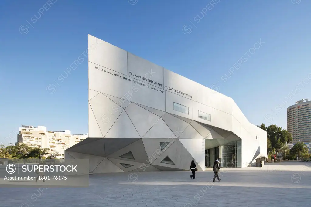 Tel Aviv Museum of Art, Tel Aviv, Israel. Architect: Preston Scott Cohen, 2011. Exterior elevation with city in background.