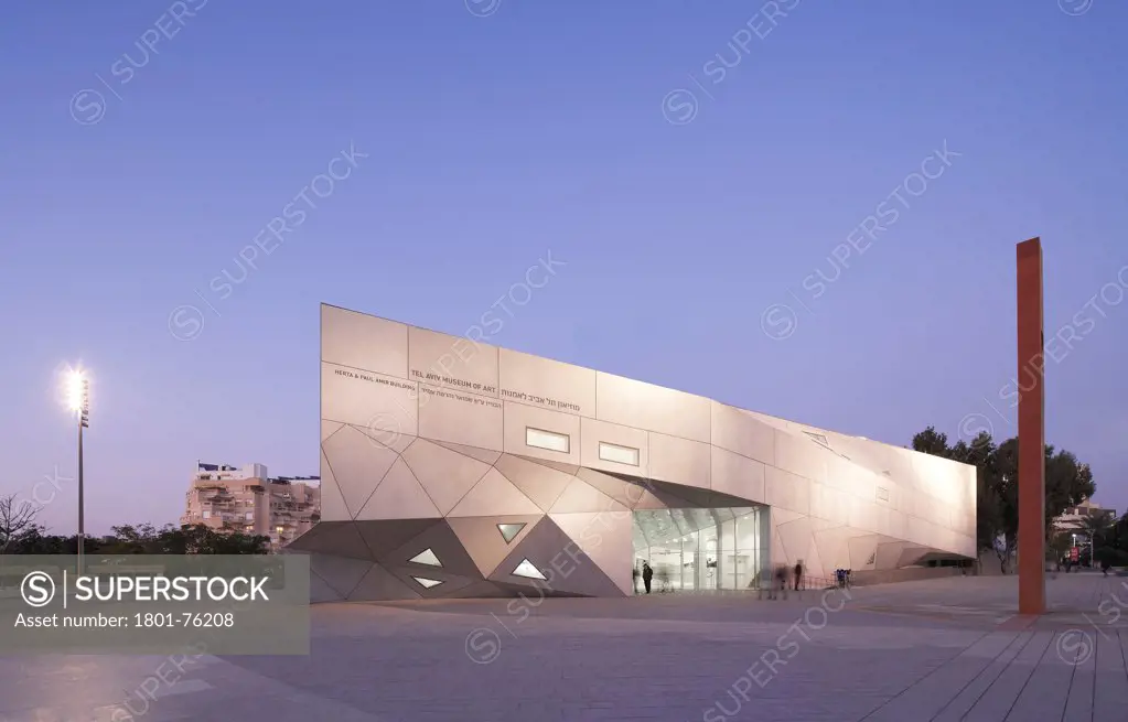 Tel Aviv Museum of Art, Tel Aviv, Israel. Architect: Preston Scott Cohen, 2011. Exterior elevation at dusk.