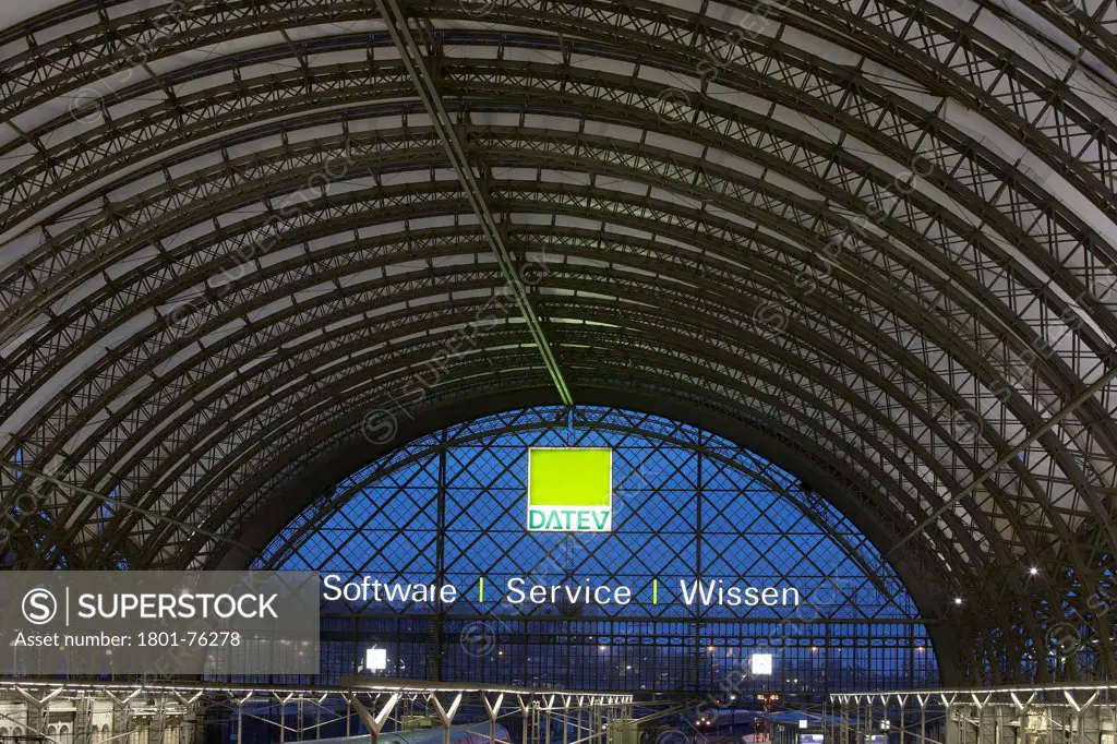 Dresden Hauptbahnhof, Dresden, Germany. Architect: Foster + Partners, 2006. General view of steelwork roof structure with translucent glass fibre skin and neon light advertising.