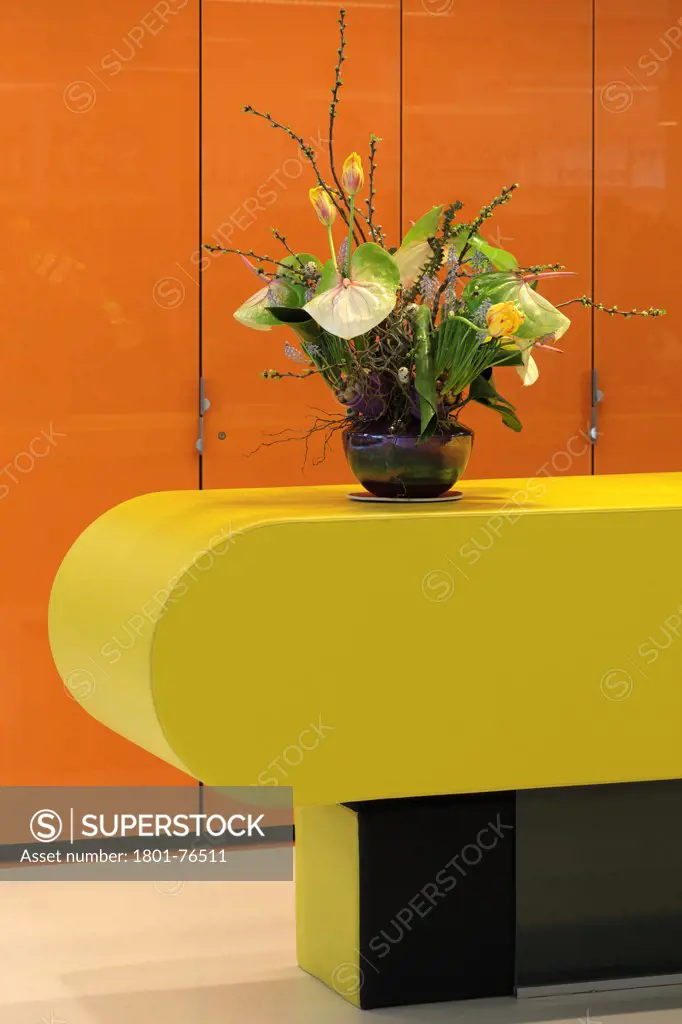 Detail of yellow receptio desk with flowers and orange wall panels, DOK Media Centre / DOK Mediatheek, Delft, The Netherlands&#xA;Architects: Dok Architecten / AEQUO (2007)