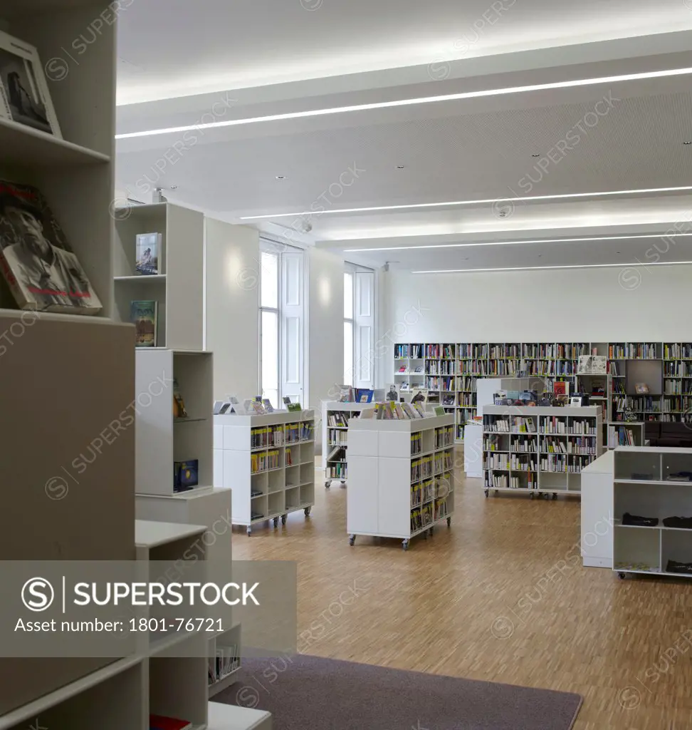 Goethe Institute, London, United Kingdom. Architect: Blauel Architects, 2012. Oblique view through library with book shelves.