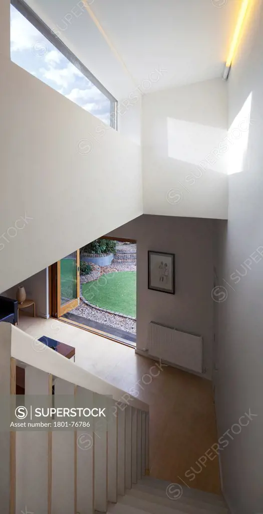 The Timber Fin House, London, United Kingdom. Architect: Neil Dusheiko Architects, 2010. Stairway with oblong skylight looking down to living space and garden.