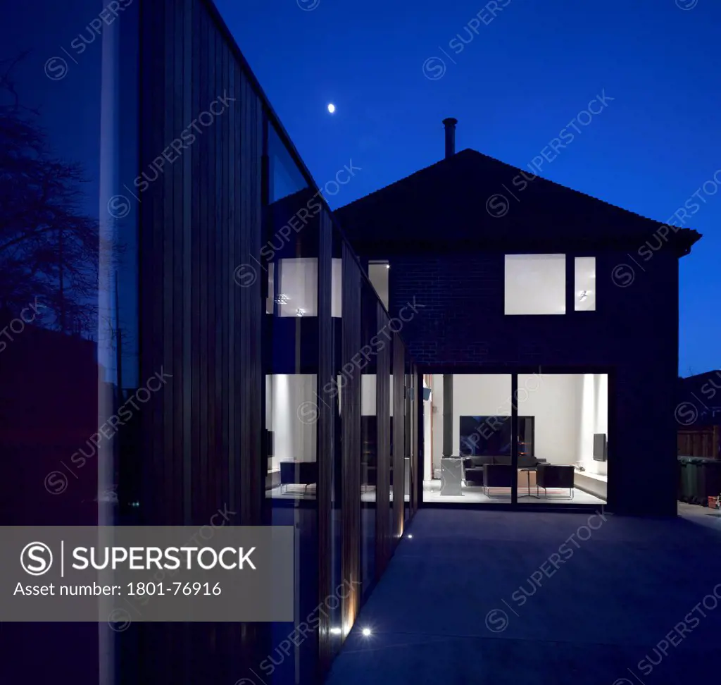 The Long House, Home Extension, Europe, United Kingdom, Hampshire, 2012, Dan Brill Architects. Twilight view from the rear.