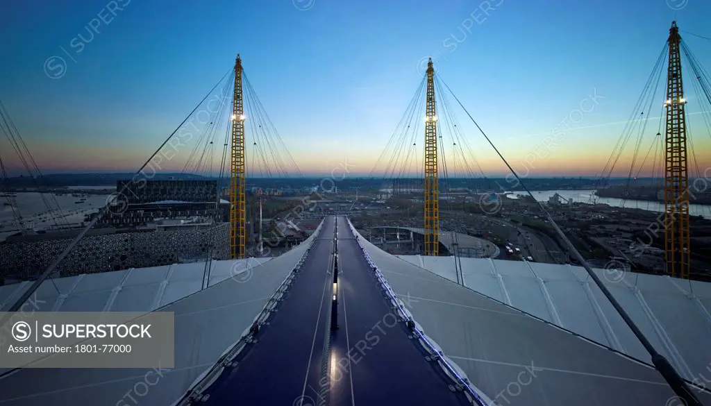 'Up at the O2'- High level walkway over the Millenium Dome, London, United Kingdom. Architect: Rogers Stirk Harbour + Partners, 2012. View from viewing platform at dusk.